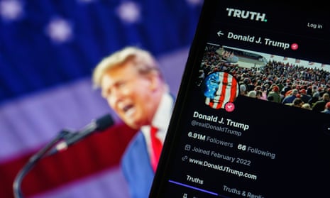 A photo composite of Donald Trump on the left, blurry and in the background, speaking into a mic in front of a US flag, and computer screen on right shows black screen and Truth social.