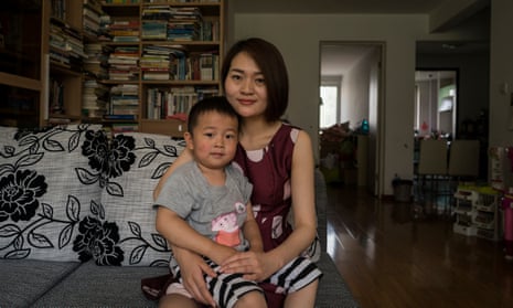 Li Wenzu, 31, wife of imprisoned lawyer Wang Quanzhang poses for a portrait with their son Wang Guangwei, 3.