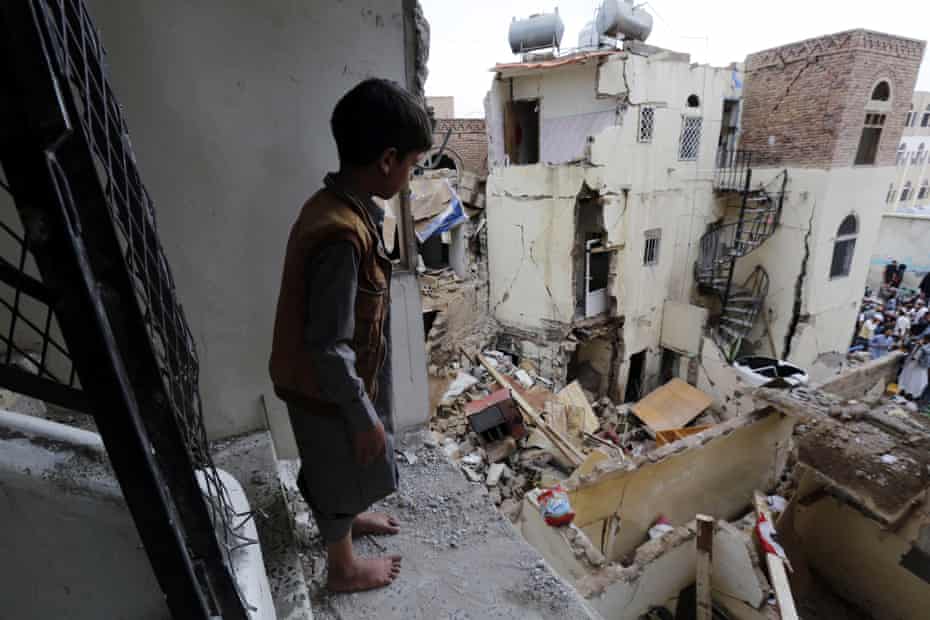 A boy looks over destroyed houses the day after a Saudi-led airstrike in Sanaa