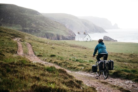 Cyclist approaches Kearvaig Bay, Scotland.