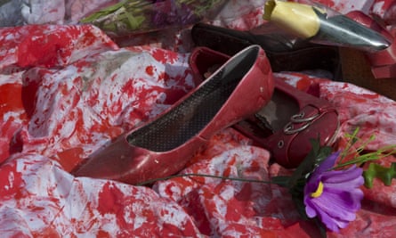 Red shoes and flowers placed by members of a women’s group to promote International Women’s Day in Puerta del Sol square in Madrid, Spain.