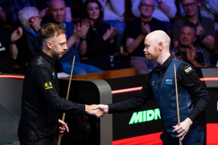 Judd Trump (left) and Gary Wilson shake hands at the end of their match.
