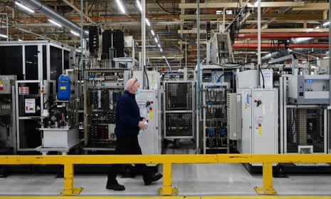A worker passes some of the gear assembly production line in Ford's Halewood plant on Merseyside.
