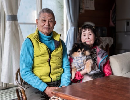 Hideya and Mihoko Yagi with their dog at home.
