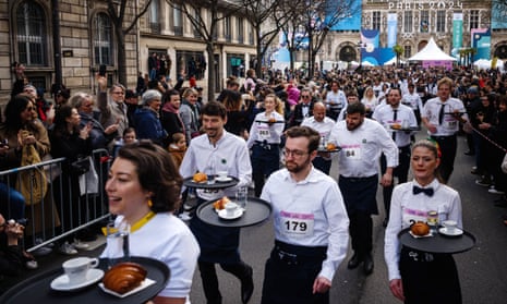 Waiters take part in the Course des Cafés in Paris
