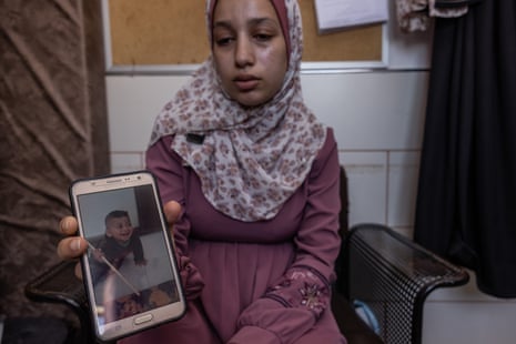 May Al-Masri holds a picture of her son Yasser, killed by a rocket outside her home. She was pregnant at the time.