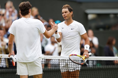Rafael Nadal and Taylor Fritz shake hands after their match.