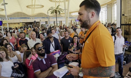 An easyJet employee talks to stranded tourists waiting at the airport to be evacuated from Sharm el-Sheik.