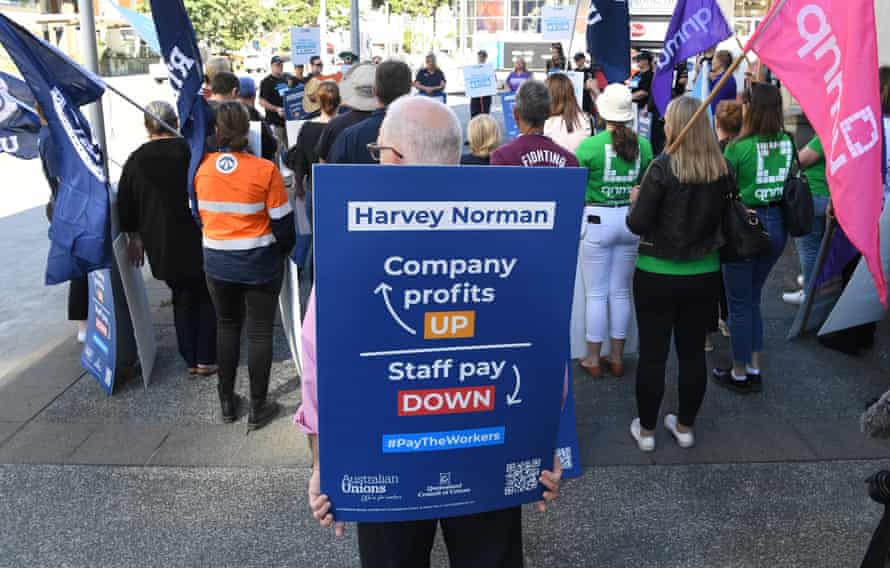 Workers are seen protesting about pay outside Harvey Norman Fortitude Valley in Brisbane