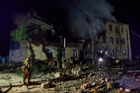 Ukrainian rescuers work at the site of a residential building after it was damaged by an explosion in Kharkiv.
