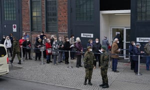 People line up outside a vaccination center in Berlin on Thursday. Many of them had arrived there in taxis, paid for by the state.
