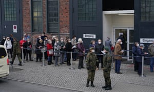 People line up outside a vaccination centre in Berlin on Thursday. Many of them had arrived there in taxis, paid for by the state.