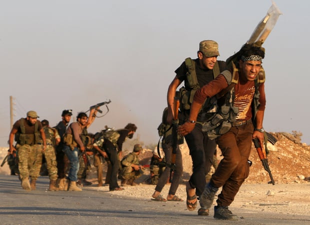 Fighters from the Free Syrian Army take part in a battle against Isis in the northern Syrian village of Yahmoul.