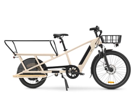 A Decathlon BTWIN Rear Loading Electric Longtail Cargo bike in beige