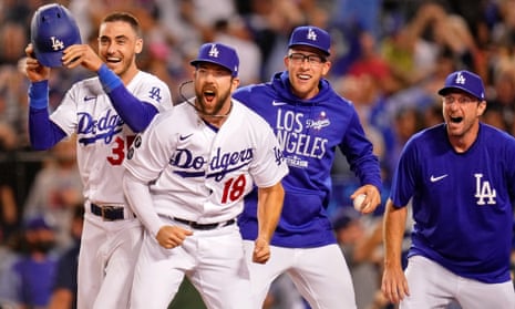 Fans wear uniforms of the Los Angeles Dodgers, left, and the Los