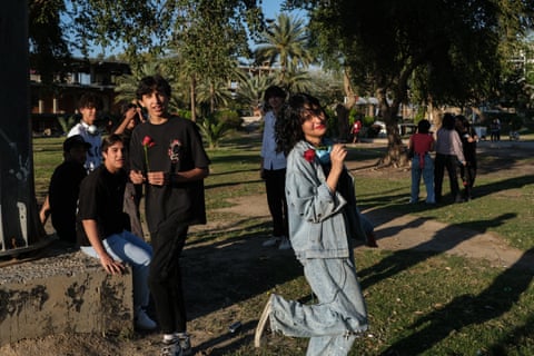 Young people hanging out in a Baghdad park.