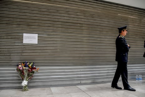 A bouquet of flowers is placed at the shopping centre, the day after five people were stabbed and one was killed in Assago, on the outskirts of Milan.