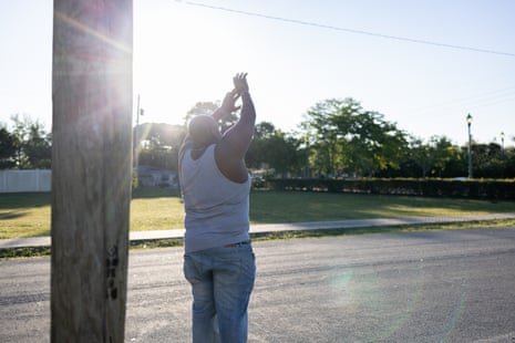 A man waves goodbye outside