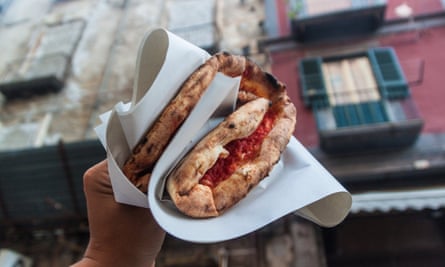 Folded Neapolitan-style pizza in hand