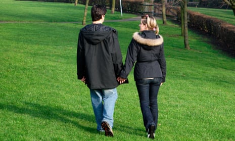 A couple walk in a park