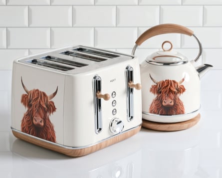 A kettle and toaster with highland cow images on them