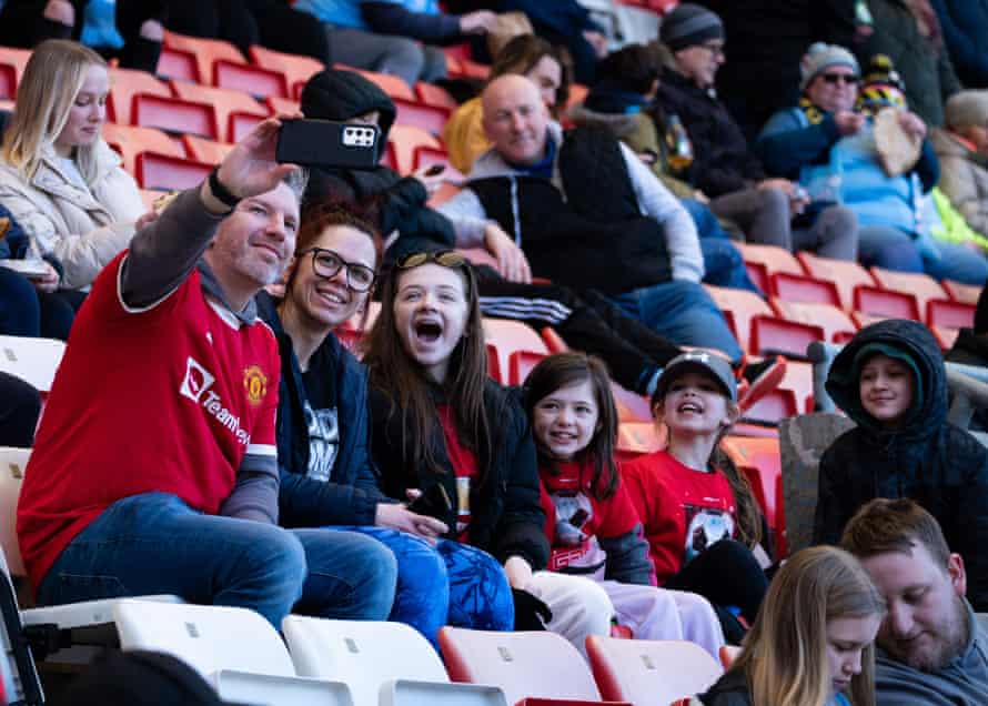 A family of Manchester United supporters take a half-time selfie.