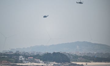 Chinese military helicopters fly over Pingtan island, the closest point in China to Taiwan's main island, in Fujian province on 19 May.