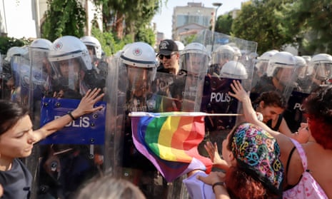 An  LGBTQ+ flag Women push against riot police shields Members of the community clash with during Pride in Izmir, Turkey, last June.