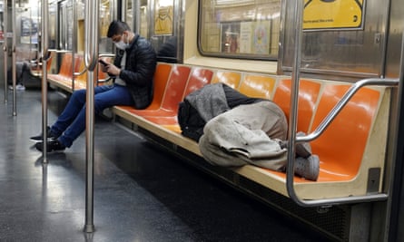 person sleeps on subway seats