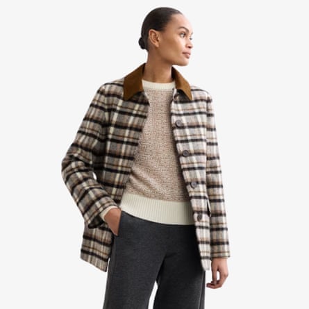 A model wears a Jaegar checked cord collar jacket with a taupe and cream top and dark trousers.