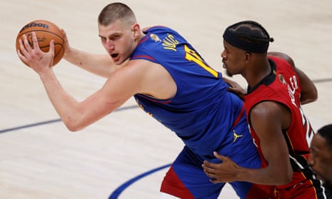 Nikola Jokić, left, recorded his ninth triple-double of the playoffs in Denver’s Game 1 win over Miami on Thursday night.