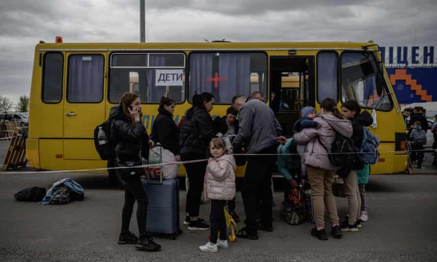 Families from Russian-occupied territories in the Zaporizhzhia region arrive in a humanitarian convoy at a registration and processing centre for internally displaced people in Zaporizhzhia.