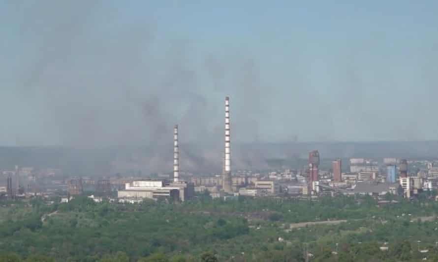 Black smoke billows over Sievierodonetsk Azot chemical plant in Sievierodonetsk, Luhansk region, Ukraine, in this still image obtained from a handout video released on June 9, 2022.