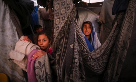Palestinian children inside a makeshift tent in Deir al-Balah.