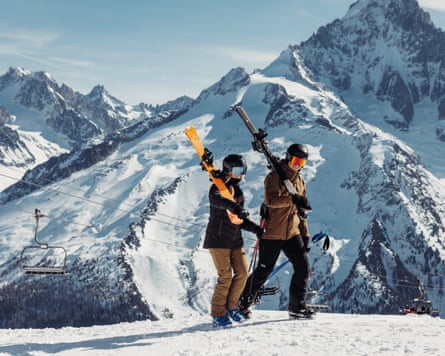 A man and a woman on a mountain range in Helly Hansen ski-wear