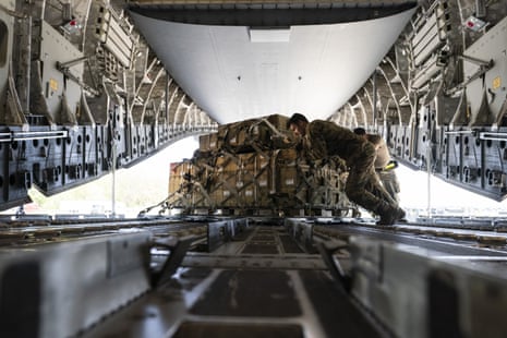 A pallet of fuses for 155 mm shells is spun as it’s loaded on to a C-17 cargo aircraft.