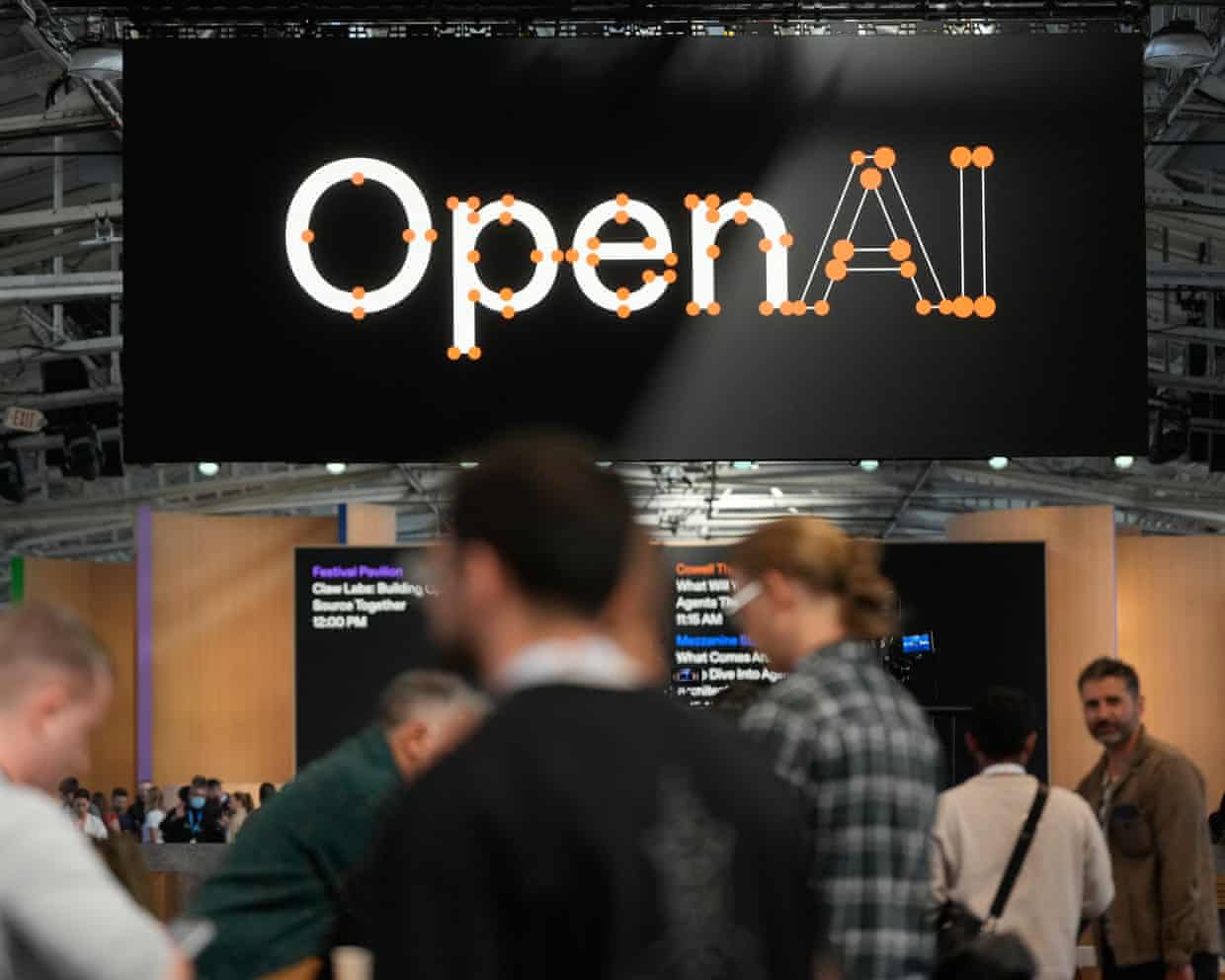 People standing around at an OpenAI conference in San Francisco