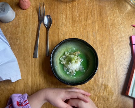 A bowl with green food in it.