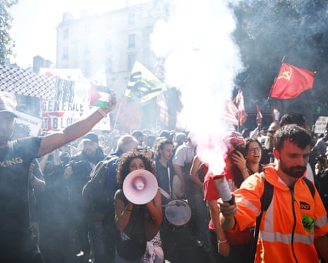 Marchers with loudhailers and flags