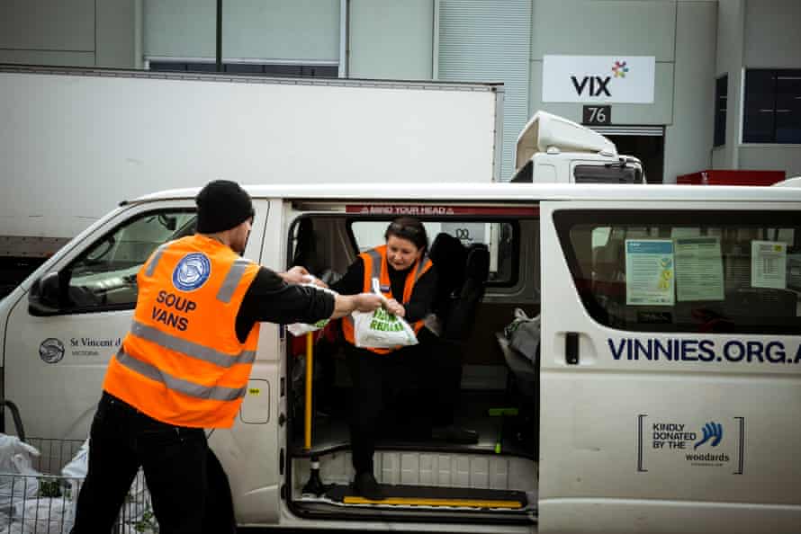 Melissa Walton helps volunteer Lewis pack a van for delivery.