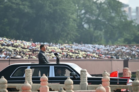 China’s President Xi Jinping inspects the troops in open-topped car.