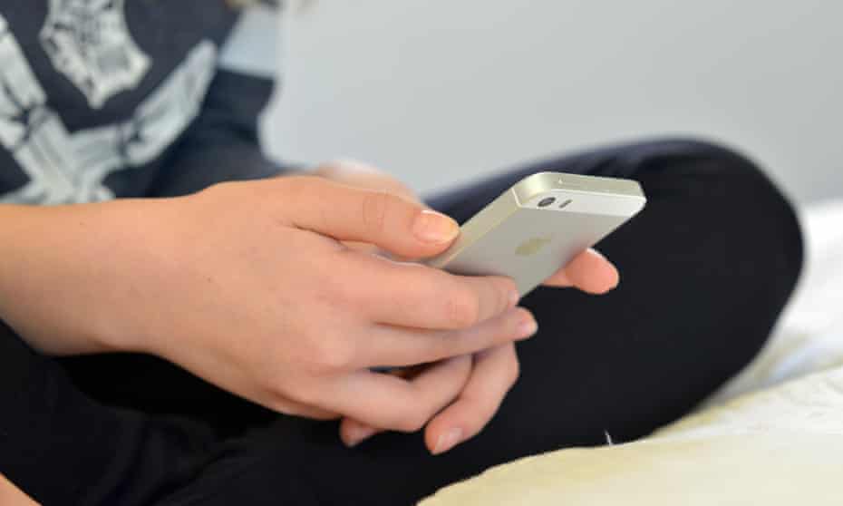 A teenage girl using a mobile phone
