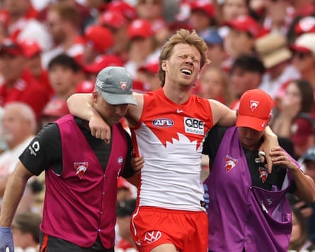 Sydney captain Callum Mills is helped from the field during an AFL qualifying final against Brisbane