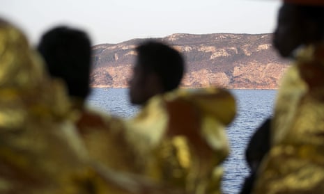 Rescued refugees and migrants arrive at Trapani harbour in Sicily