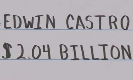 A screen capture of a livestreamed video from WESH-TV showing an oversized check containing the name of the winner of the historic $2.04bn Powerball jackpot on 8 November.