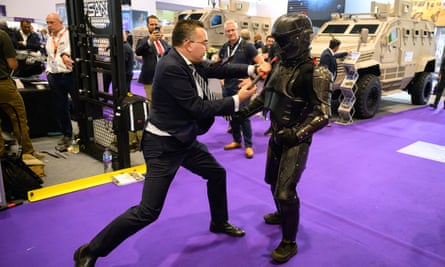 A man wearing a Chiron-X1 high-impact close-quarter fighting training suit is attacked by a member of the sales team during a demonstration at DSEI