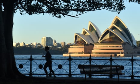 A lone jogger with the Opera House in the background