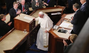 Pope Francis finishes his address to Congress, leaving his glass of water, left.