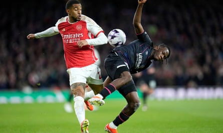 Reiss Nelson of Arsenal competes for the ball with Luton’s Issa Kaboré.