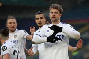 Leeds United’s English striker Patrick Bamford celebrates with teammates after scoring the opening goal.